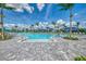 Resort-style pool featuring ample lounge chairs and umbrellas, perfect for relaxation and leisure at 12470 Wellen Golf St # 207, Venice, FL 34293