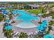 Amazing community pool area with sun shelves, fountains, turquoise umbrellas, palm trees, and lounge chairs at 12470 Wellen Golf St # 207, Venice, FL 34293