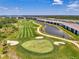 Scenic aerial view of community condos with a pond, and golf course at 12470 Wellen Golf St # 208, Venice, FL 34293