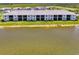 Aerial view of a condo with patios or balconies and golf course, overlooking a peaceful pond at 12470 Wellen Golf St # 208, Venice, FL 34293