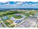 Panoramic aerial view of a vibrant baseball stadium surrounded by lush greenery, training fields, and extensive parking at 12470 Wellen Golf St # 208, Venice, FL 34293