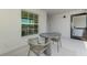 View from balcony with seating, table, and light fixture showcasing neutral tones at 12470 Wellen Golf St # 208, Venice, FL 34293