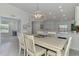 Dining area features contemporary lighting and open floor plan at 12470 Wellen Golf St # 208, Venice, FL 34293