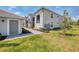 Exterior townhome view showcasing manicured lawn and walkway, and gray color palette at 12470 Wellen Golf St # 208, Venice, FL 34293
