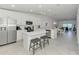 Bright, open kitchen featuring modern appliances, island with seating, and open concept living at 12470 Wellen Golf St # 208, Venice, FL 34293