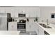 Close up of the kitchen featuring stainless steel appliances and white cabinets at 12470 Wellen Golf St # 208, Venice, FL 34293