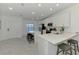 Contemporary kitchen featuring quartz countertops, an island with seating, and stainless appliances at 12470 Wellen Golf St # 208, Venice, FL 34293