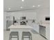 Bright kitchen boasts white cabinets, stainless steel appliances, and a center island with seating at 12470 Wellen Golf St # 208, Venice, FL 34293