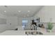 Bright kitchen features white cabinets, countertops, stainless steel appliances, and an island at 12470 Wellen Golf St # 208, Venice, FL 34293