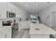 View of open kitchen and stainless steel appliances at 12470 Wellen Golf St # 208, Venice, FL 34293