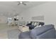 Comfortable living room with neutral paint, ceiling fan and an open floor plan to the dining area and kitchen at 12470 Wellen Golf St # 208, Venice, FL 34293