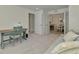 Bright living room with a desk, chair and sofa that is adjacent to the dining and kitchen area at 12470 Wellen Golf St # 208, Venice, FL 34293