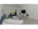 Bright living room with tile floor, ceiling fan and sliding doors to the lanai with lovely golf course views at 12470 Wellen Golf St # 208, Venice, FL 34293