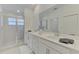 Bright main bathroom with double sinks, stone countertops and step-in shower at 12470 Wellen Golf St # 208, Venice, FL 34293