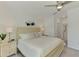 Spacious main bedroom with ceiling fan and view into ensuite bathroom at 12470 Wellen Golf St # 208, Venice, FL 34293