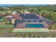 Aerial view of a house with a pool, solar panels, tennis court, shuffleboard and waterfront access at 1275 Bayshore Dr, Englewood, FL 34223