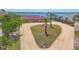 Aerial view of the home, long driveway, front lawn, and bay view at 1275 Bayshore Dr, Englewood, FL 34223