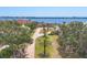 Aerial view of long driveway and front lawn with view of the bay at 1275 Bayshore Dr, Englewood, FL 34223