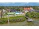 Stunning waterfront property featuring putting green, pool, dock, and beautiful landscaping at 1275 Bayshore Dr, Englewood, FL 34223