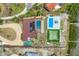 Aerial view showcases the pool, tennis court, golf course and waterfront access of this property at 1275 Bayshore Dr, Englewood, FL 34223