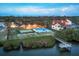 Aerial view of waterfront homes featuring pools, manicured lawns, and boat dock at 1275 Bayshore Dr, Englewood, FL 34223