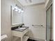 Well-lit bathroom featuring walk-in shower and single sink vanity at 1275 Bayshore Dr, Englewood, FL 34223