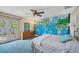 Comfortable bedroom with world map accent wall and French doors to the outside at 1275 Bayshore Dr, Englewood, FL 34223