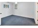 Cozy bedroom with neutral walls, base trim, and blue carpeting at 1275 Bayshore Dr, Englewood, FL 34223