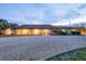 Charming home featuring classic white columns, neutral stucco, and a circular driveway at 1275 Bayshore Dr, Englewood, FL 34223