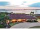 Waterfront home featuring a beautiful backyard, well manicured landscaping and a circular driveway at 1275 Bayshore Dr, Englewood, FL 34223