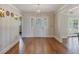 Bright foyer features hardwood floors and a decorative glass front door at 1275 Bayshore Dr, Englewood, FL 34223
