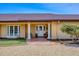 Charming entryway with brick walkway and covered porch with white columns at 1275 Bayshore Dr, Englewood, FL 34223