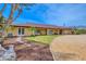 One-story home with stone accents, manicured lawn, circle drive, and covered entryway at 1275 Bayshore Dr, Englewood, FL 34223