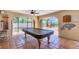 Entertaining game room with billiard table leading to outdoor living at 1275 Bayshore Dr, Englewood, FL 34223