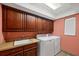Well-organized laundry room with sink and built-in storage at 1275 Bayshore Dr, Englewood, FL 34223