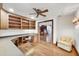 Dedicated office space with custom built-ins, ceiling fan, and hardwood floors at 1275 Bayshore Dr, Englewood, FL 34223