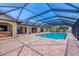 The screened-in pool is surrounded by brick and a patio, creating a luxurious outdoor living space at 1275 Bayshore Dr, Englewood, FL 34223