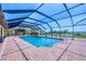 Gorgeous screened-in pool surrounded by brick, offering a refreshing retreat with lovely water views at 1275 Bayshore Dr, Englewood, FL 34223