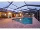 Spacious pool with brick pavers and screened enclosure at 1275 Bayshore Dr, Englewood, FL 34223