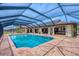 Inviting screened-in pool and a spacious outdoor patio are perfect for entertaining and relaxing at 1275 Bayshore Dr, Englewood, FL 34223