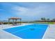 Bright blue tennis court next to a covered table, perfect for outdoor games and relaxation at 1275 Bayshore Dr, Englewood, FL 34223