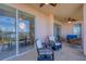 Spacious covered balcony with comfortable seating and chandelier, perfect for relaxation and enjoying the views at 13113 Gasparilla Rd # A503, Placida, FL 33946