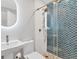 Modern bathroom with glass shower, decorative tile, and stylish gold fixtures at 13113 Gasparilla Rd # A503, Placida, FL 33946