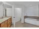 Bathroom featuring a soaking tub, and a wood vanity with granite counter at 13113 Gasparilla Rd # A503, Placida, FL 33946