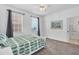 Bright bedroom with a queen-size bed, ceiling fan, and large window at 13113 Gasparilla Rd # A503, Placida, FL 33946