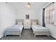 Comfortable bedroom with two twin beds, soft carpeting, and a bright window for natural light at 13113 Gasparilla Rd # A503, Placida, FL 33946