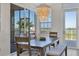 Dining room featuring an ornate chandelier, a dining table with bench seating, and bright natural light at 13113 Gasparilla Rd # A503, Placida, FL 33946