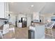 Bright kitchen with white cabinets, stainless appliances, plenty of counterspace, and wood-look tile floors at 13113 Gasparilla Rd # A503, Placida, FL 33946