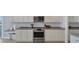 Bright kitchen featuring white cabinets and stainless steel appliances at 13113 Gasparilla Rd # A503, Placida, FL 33946