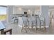 Bright kitchen with white cabinets, stainless appliances, and a breakfast bar with seating overlooking the balcony at 13113 Gasparilla Rd # A503, Placida, FL 33946